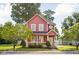 Charming two-story home featuring a red exterior, white trim, and inviting front porch at 2015 N College Ave, Indianapolis, IN 46202