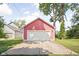Detached garage with a white door and ample driveway space at 2015 N College Ave, Indianapolis, IN 46202