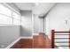 Bright upstairs hallway with hardwood floors and natural light, connecting various rooms, provides an open and airy feel at 2015 N College Ave, Indianapolis, IN 46202
