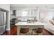 A stylish kitchen featuring a marble island, stainless steel appliances, and modern white and green cabinetry at 2015 N College Ave, Indianapolis, IN 46202