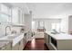 Modern kitchen with white cabinets, farmhouse sink, island, and stainless steel appliances at 2015 N College Ave, Indianapolis, IN 46202