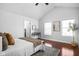 Bright main bedroom with vaulted ceiling, hardwood floors, and natural light from large windows at 2015 N College Ave, Indianapolis, IN 46202