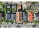This aerial view shows several houses in a residential area on tree lined streets with cars parked on the road at 2332 Central Ave, Indianapolis, IN 46205