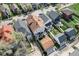 An aerial view shows the home with a fenced yard and detached garage near other houses on a tree lined street at 2332 Central Ave, Indianapolis, IN 46205
