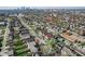 This aerial captures a cityscape featuring tree-lined streets, diverse homes, and a downtown skyline in the background at 2332 Central Ave, Indianapolis, IN 46205
