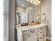 Bright bathroom featuring a double sink vanity with a large mirror and natural light from the window at 2332 Central Ave, Indianapolis, IN 46205