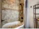 Bathroom featuring a bathtub, shower with tiled walls, and a shower head for a relaxing bathing experience at 2332 Central Ave, Indianapolis, IN 46205