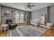 Cozy bedroom featuring a gray armchair, a large area rug, and hardwood floors at 2332 Central Ave, Indianapolis, IN 46205