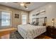 Bedroom showcasing stylish bedding, two windows, hardwood floors, and ceiling fan at 2332 Central Ave, Indianapolis, IN 46205