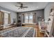 Charming bedroom with a crib, gray walls, hardwood floors, and a ceiling fan at 2332 Central Ave, Indianapolis, IN 46205