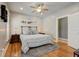 Bedroom featuring a plush rug, hardwood floors, two windows, and ample space at 2332 Central Ave, Indianapolis, IN 46205