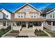 Charming two-story home with a covered front porch, beautiful landscaping, and classic architectural details at 2332 Central Ave, Indianapolis, IN 46205