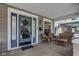 Charming front porch with wicker seating, blue door, wreath, and a welcoming atmosphere for relaxing at 2332 Central Ave, Indianapolis, IN 46205