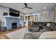 Comfortable living room featuring a fireplace, large sectional sofa, and views into the kitchen at 2332 Central Ave, Indianapolis, IN 46205