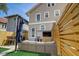 Cozy patio features a modern outdoor sofa, a mounted flatscreen TV, and privacy fencing at 2332 Central Ave, Indianapolis, IN 46205