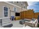 Cozy patio features a modern outdoor sofa, a fire pit, and privacy fencing, perfect for entertaining at 2332 Central Ave, Indianapolis, IN 46205