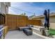 This outdoor patio space features a gas firepit and outdoor sectional sofa, as well as privacy fencing at 2332 Central Ave, Indianapolis, IN 46205