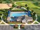 Aerial view of a community pool with ample lounge seating and a clubhouse nearby at 2755 Muirfield St, Franklin, IN 46131