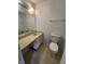 Bathroom featuring a white toilet, mirror, and sink at 3415 Winchester Dr, Indianapolis, IN 46227