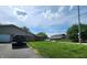 View of the home's driveway, landscaping, and surrounding neighborhood on a sunny day at 3415 Winchester Dr, Indianapolis, IN 46227
