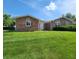 Well-kept brick house with a neat lawn, inviting entrance, and classic architectural style at 3415 Winchester Dr, Indianapolis, IN 46227