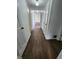 Hallway featuring wood floors and white doors leading to various rooms at 3415 Winchester Dr, Indianapolis, IN 46227