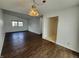 Spacious living room with hardwood floors, natural light, and a classic light fixture at 3415 Winchester Dr, Indianapolis, IN 46227
