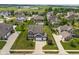Aerial view of a beautiful home with manicured lawn, spacious driveway, and well-maintained landscaping at 3679 Woodruff Pl, Bargersville, IN 46106