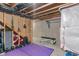 Basement workout area with concrete walls, weights, and a bench at 3679 Woodruff Pl, Bargersville, IN 46106