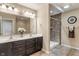 Bathroom with dual vanity sinks and a glass door shower featuring tiled walls at 3679 Woodruff Pl, Bargersville, IN 46106