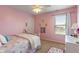 Charming pink bedroom with natural light, unicorn decorations, and carpet flooring at 3679 Woodruff Pl, Bargersville, IN 46106
