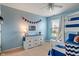 Bright blue bedroom with bunk beds, dresser and window allowing natural light at 3679 Woodruff Pl, Bargersville, IN 46106