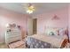 Lovely pink bedroom with floral rug, white dresser, canopy bed, and decor at 3679 Woodruff Pl, Bargersville, IN 46106