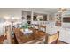 Open concept dining room with hardwood floors, farm table and seating, opening to the kitchen and living room at 3679 Woodruff Pl, Bargersville, IN 46106