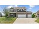 Charming two-story home featuring a brick facade, three-car garage, and well-manicured front lawn at 3679 Woodruff Pl, Bargersville, IN 46106