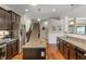 Kitchen featuring granite countertops, stainless steel appliances, dark wood cabinets, and a kitchen island with a sink at 3679 Woodruff Pl, Bargersville, IN 46106
