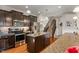 A kitchen with stainless steel appliances, dark brown cabinets, an island with sink, granite countertops, and hardwood floors at 3679 Woodruff Pl, Bargersville, IN 46106