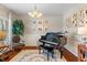 Elegant living room featuring a grand piano, classic decor, and ample natural light at 3679 Woodruff Pl, Bargersville, IN 46106
