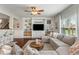Living room with built-in shelving, a large sectional sofa, round coffee table, ceiling fan, and hardwood floors at 3679 Woodruff Pl, Bargersville, IN 46106