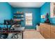 Office with blue walls, built-in shelves, a large desk, and natural light from the window at 3679 Woodruff Pl, Bargersville, IN 46106