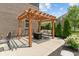 Inviting patio with a pergola, comfortable seating, a fire pit, and manicured landscaping at 3679 Woodruff Pl, Bargersville, IN 46106