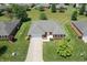 Aerial view of a brick home with a manicured lawn, complemented by lush trees and neighborhood landscaping at 370 Vinewood S Dr, Brownsburg, IN 46112