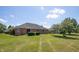 View of the home's rear exterior with sliding glass doors and well-maintained landscaping at 370 Vinewood S Dr, Brownsburg, IN 46112