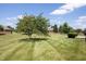 Spacious green backyard with lush lawn and mature shade trees, perfect for outdoor activities at 370 Vinewood S Dr, Brownsburg, IN 46112