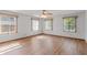 Bedroom featuring three windows for natural light, ceiling fan, and wood-look flooring at 370 Vinewood S Dr, Brownsburg, IN 46112