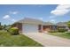 Beautifully landscaped brick home with a well-maintained lawn and a two-car garage at 370 Vinewood S Dr, Brownsburg, IN 46112