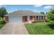 Charming single-story brick home with a well-manicured lawn and an attached two-car garage at 370 Vinewood S Dr, Brownsburg, IN 46112