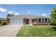 Charming single-story brick home featuring a well-manicured lawn and an attached two-car garage at 370 Vinewood S Dr, Brownsburg, IN 46112