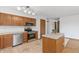 Open kitchen featuring stainless steel appliances, wooden cabinets, and a functional island at 370 Vinewood S Dr, Brownsburg, IN 46112