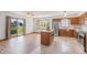 Bright kitchen-dining area with a sliding glass door, stainless appliances, and wood flooring for an open and inviting space at 370 Vinewood S Dr, Brownsburg, IN 46112